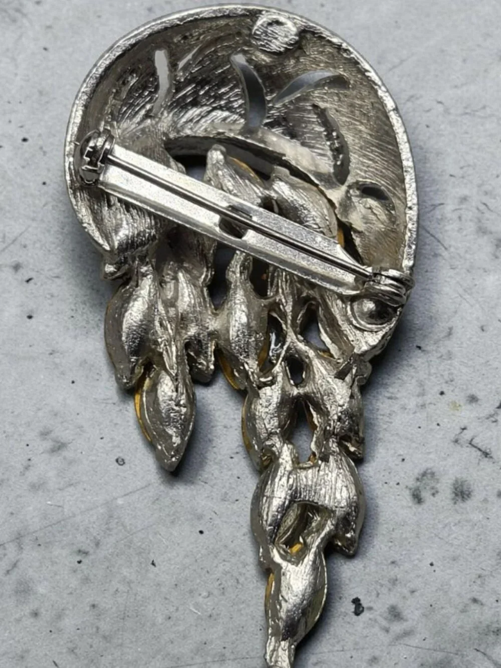 None this brooch